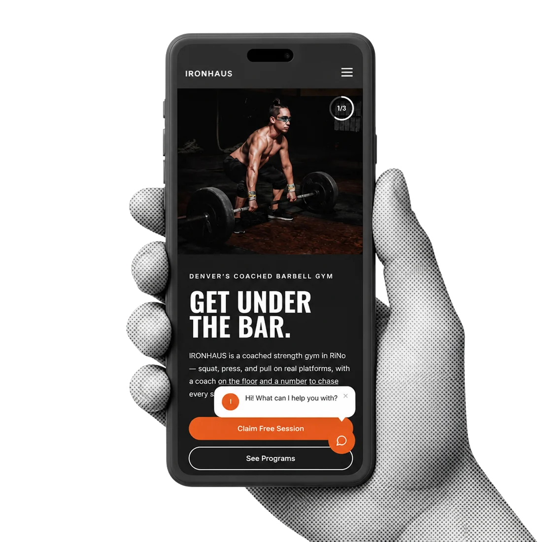 Ironhaus, a gym site built by Web Factory, held on a phone